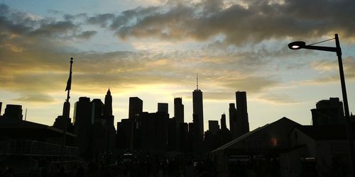 View of skyscrapers against cloudy sky