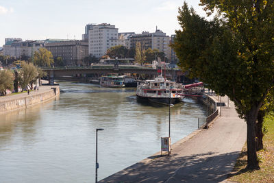 Bridge over river in city against sky