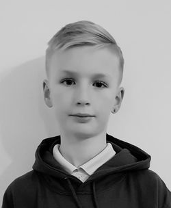 Portrait of cute boy against white background