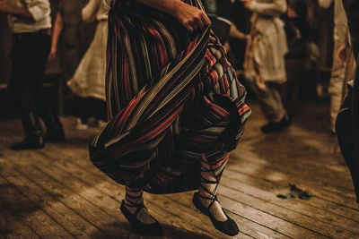 Low section of woman dancing on hardwood floor