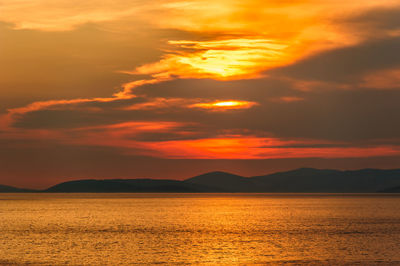 Scenic view of sea against romantic sky at sunset