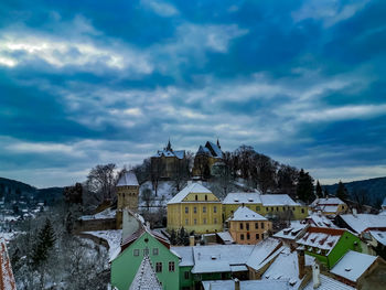 Houses in town against sky