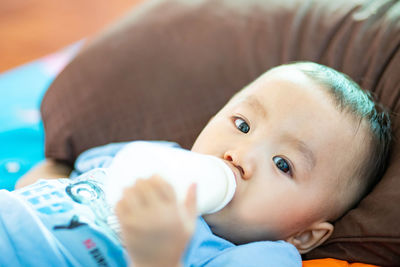 Portrait of cute baby lying on bed