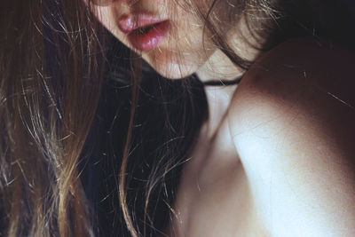 Close-up of sensuous topless woman with long hair