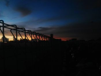 Silhouette bridge against sky during sunset