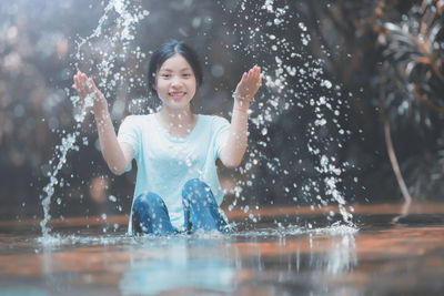 Portrait of happy girl in water