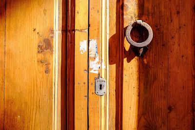 Close-up of doorknob and keyhole on sunny day