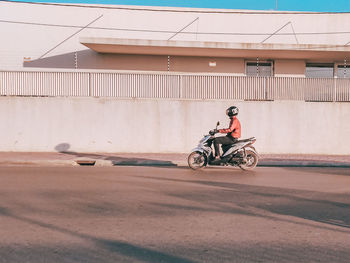 Man riding bicycle on road