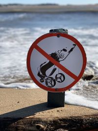 Close-up of sign on beach