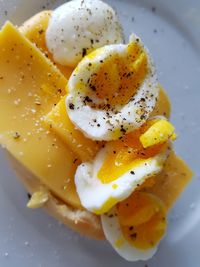 Close-up of egg and cheese in plate on table