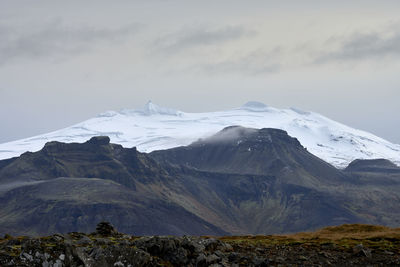 Snowy mountain range in evening