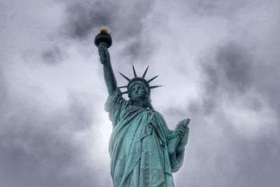 Statue of liberty against cloudy sky