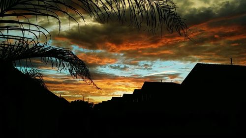 Silhouette of building against dramatic sky