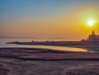Scenic view of beach against sky during sunset