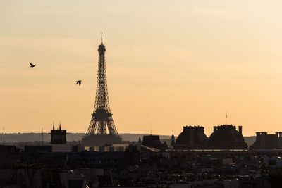 View of buildings in city against sky during sunset