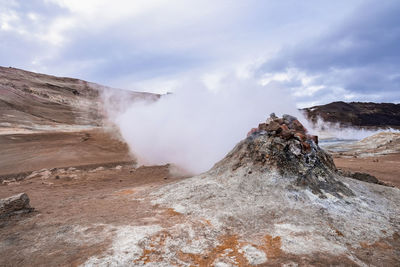 View of steam emitting from fumarole in geothermal area of hverir at namafjall