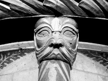 Low angle view of statue against stone wall