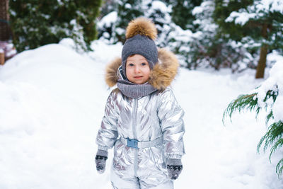 In winter, child plays in snow. winter scene with child. happy childhood.