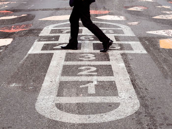 Low section of man walking on street