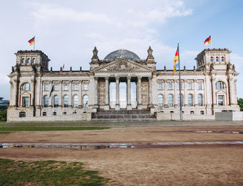 Facade of historical building in city against sky