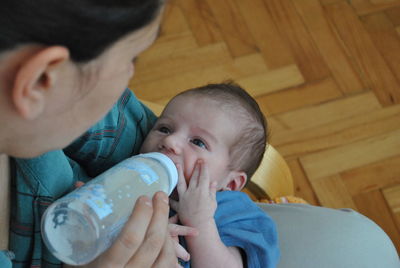 Portrait of cute boy playing with baby