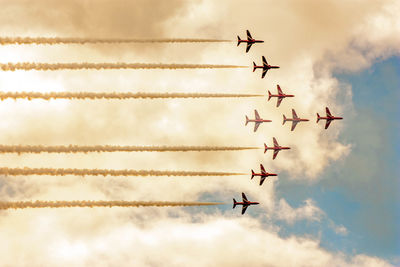 Low angle view of airshow against sky