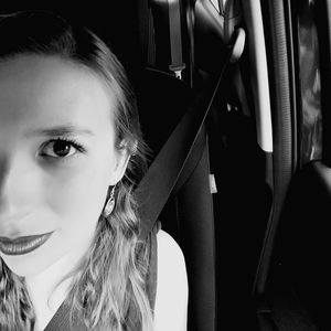 Close-up portrait of beautiful woman in car