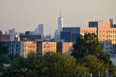 Buildings in city against clear sky