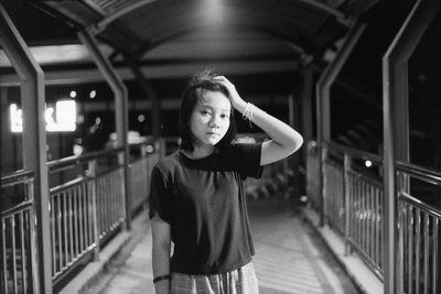 Portrait of boy standing on railing