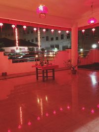 Red chairs in illuminated room