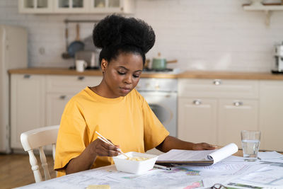 Woman holding ice cream at home