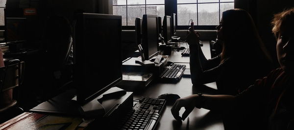 Students using computers in school during rainy season