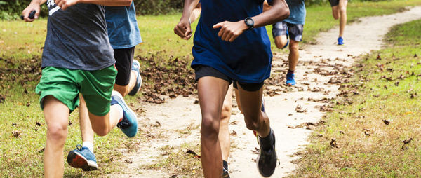 Low section of people running on field