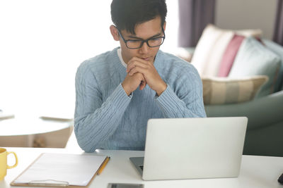 Midsection of man using laptop