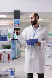 Portrait of female doctor standing in laboratory