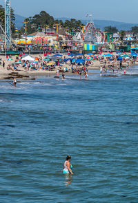 People at beach against sky