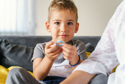 Boy sitting on sofa