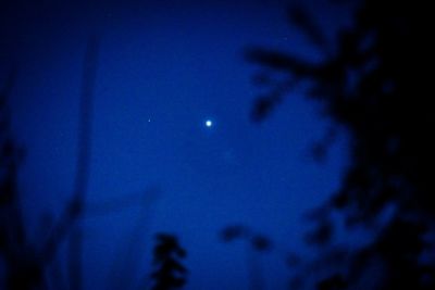 Low angle view of moon against blue sky