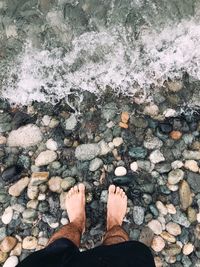 Low section of person standing on rock