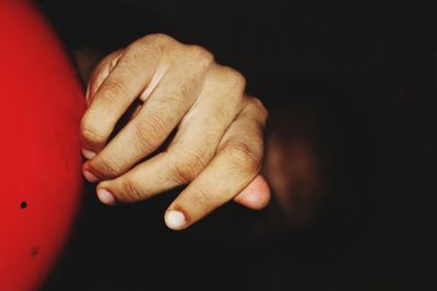 Close-up of woman hand over black background