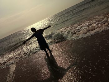 Full length of man at beach against sky