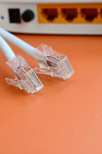 Close-up of network plugs and equipment on orange background