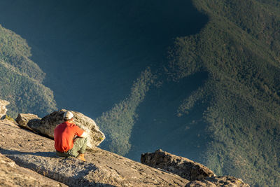 Rear view of man sitting on a rock in the yosemite national park 