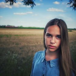 Portrait of teenage girl on field