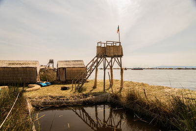 Traditional watchtower by the titicaca lake against sky