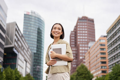 Portrait of young woman using mobile phone