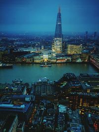 High angle view of city lit up at night