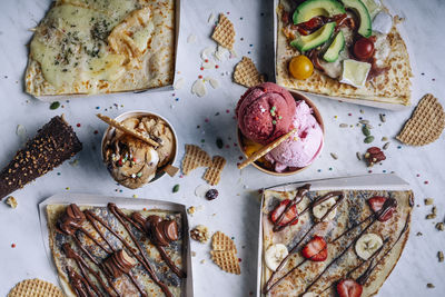 Aerial view of variety of crepes and ice creams on table