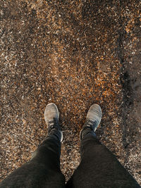 Low section of man standing on street