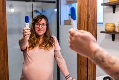 Young woman holding hands at home